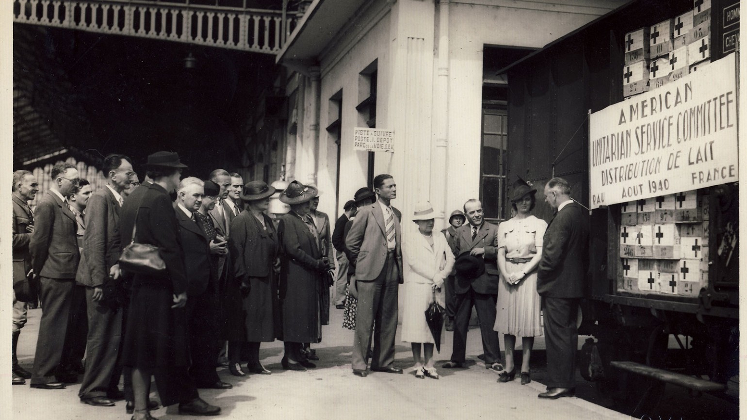 Martha Sharp presents a train load of powdered milk to the Mayor of Pau, France, 1940. Photo courtesy of Sharp Family Archives.